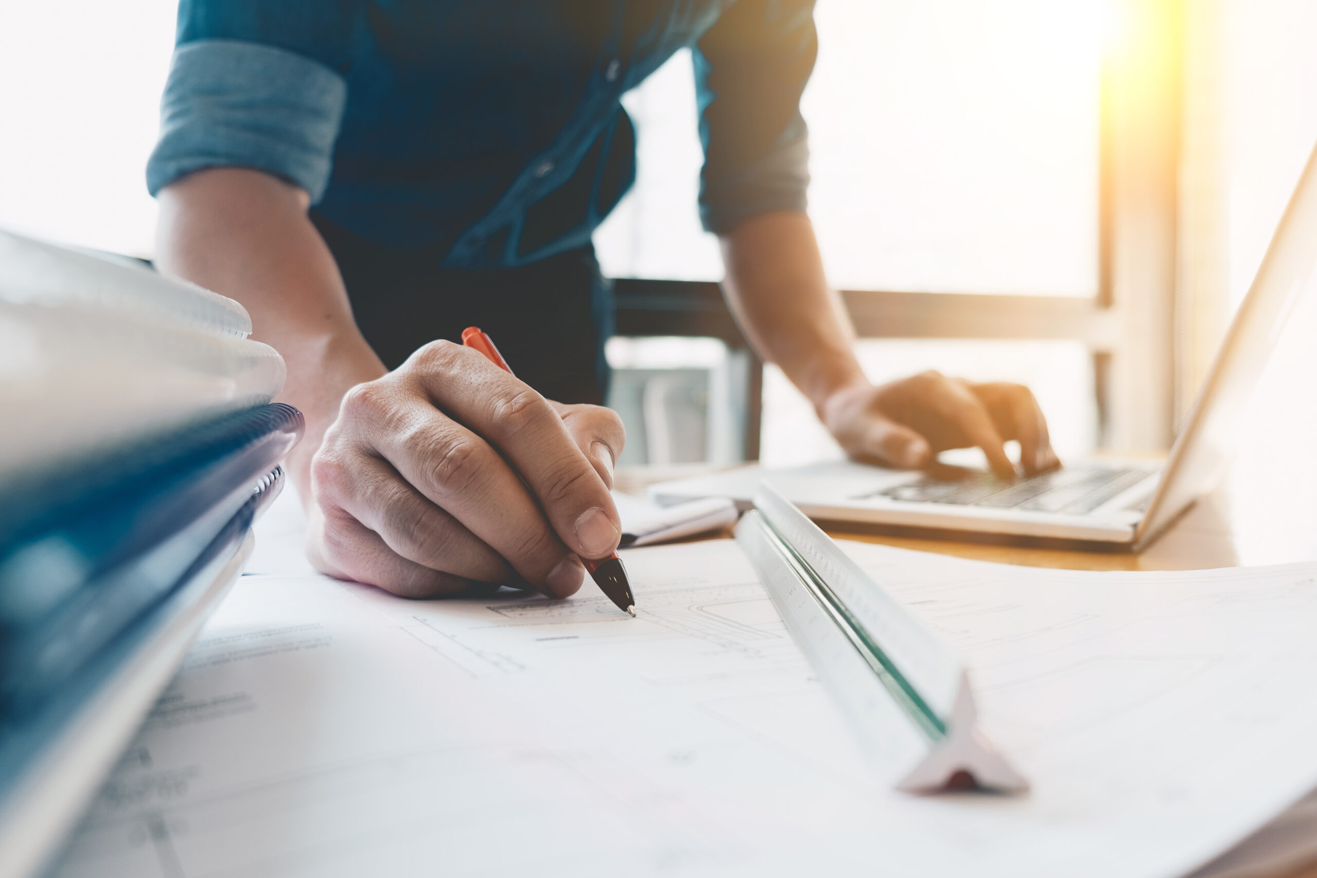 Image of engineer drawing a blue print design building or house